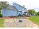 Landscaped backyard with a stone patio, fire pit, and a deck, ideal for outdoor relaxation and entertainment at 2024 Stonewyck Ave, Kannapolis, NC 28081