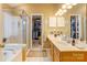 Bright bathroom with a tiled shower, double vanity, and a view to the walk-in closet at 2024 Stonewyck Ave, Kannapolis, NC 28081