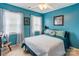 Comfortable bedroom with ample natural light, light blue walls, and a ceiling fan at 2024 Stonewyck Ave, Kannapolis, NC 28081