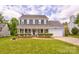 Charming two-story home features a well-manicured lawn and inviting front porch at 2024 Stonewyck Ave, Kannapolis, NC 28081