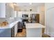Bright kitchen with stainless steel appliances, white cabinets, and an island at 2024 Stonewyck Ave, Kannapolis, NC 28081