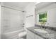 This is a clean bathroom with a granite countertop and white cabinets, and a shower and tub combo at 210 N Correll St, Landis, NC 28025