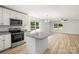 Modern kitchen with stainless steel appliances, granite countertops, and a convenient center island at 210 N Correll St, Landis, NC 28025