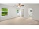 Spacious bedroom with neutral carpet, white walls, two windows, and an ensuite bathroom at 212 N Correll St, Landis, NC 28025