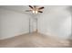 Bright bedroom with carpet flooring, a ceiling fan, and an open doorway at 212 N Correll St, Landis, NC 28025