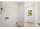 Laundry room with shelving and light-colored wood-look floors near the back door at 212 N Correll St, Landis, NC 28025