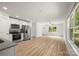 Bright open concept living room with white walls and light wood floors leading to the kitchen at 212 N Correll St, Landis, NC 28025