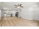 Open concept living room with modern fan, light hardwood floors, and bright white paint at 212 N Correll St, Landis, NC 28025