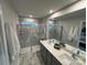 Well lit bathroom with a marble countertop and shower with glass door at 216 Laura Elizabeth Ln, Clover, SC 29710