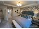 Well decorated bedroom with a large bed, stylish accent wall and lighting at 216 Laura Elizabeth Ln, Clover, SC 29710