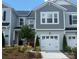 Charming two-story townhome with gray siding and a two-car garage, complemented by a well-maintained lawn at 216 Laura Elizabeth Ln, Clover, SC 29710