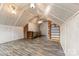 Finished attic featuring built-in shelving, contemporary flooring, and a ceiling fan at 217 S Highland St, Gastonia, NC 28052