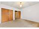 Carpeted bedroom featuring double closets and access to a secondary room at 217 S Highland St, Gastonia, NC 28052