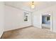Bright bedroom with neutral carpeting, white walls, and a window, providing a blank canvas for customization at 217 S Highland St, Gastonia, NC 28052