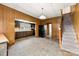 Kitchen, staircase, and open doorways in a home with wood paneling at 217 S Highland St, Gastonia, NC 28052