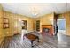 Open living room with fireplace, built in shelves, and laminated wood flooring at 217 S Highland St, Gastonia, NC 28052