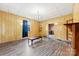 Spacious living room features wood paneled walls and laminated wood flooring at 217 S Highland St, Gastonia, NC 28052