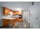Spacious eat-in kitchen with wood cabinetry and view to the hallway at 2212 10Th Ne Ave, Hickory, NC 28601