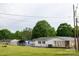 Exterior view of a home featuring a fenced yard, shed, carport and mature trees at 2212 10Th Ne Ave, Hickory, NC 28601