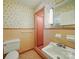 Retro bathroom featuring shower stall, sink, and vintage tile and wallpaper at 2216 Griffith Rd, Monroe, NC 28112