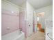 Retro bathroom with pink tile, bathtub, shower, and vintage finishes at 2216 Griffith Rd, Monroe, NC 28112