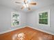 Bedroom featuring hardwood floors and two bright windows at 2216 Griffith Rd, Monroe, NC 28112