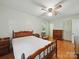 Bedroom featuring hardwood floors, bed, and vintage dresser at 2216 Griffith Rd, Monroe, NC 28112