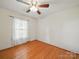 Bedroom with hardwood floors, ceiling fan, and a bright window at 2216 Griffith Rd, Monroe, NC 28112