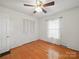 Bedroom with hardwood floors, ceiling fan, window, and closet at 2216 Griffith Rd, Monroe, NC 28112