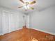 Bedroom featuring hardwood floors, ceiling fan, and closet at 2216 Griffith Rd, Monroe, NC 28112