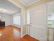 Inviting foyer with hardwood floors, a sidelight window and white trim that leads into the living spaces at 2216 Griffith Rd, Monroe, NC 28112