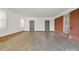 Spacious garage featuring gray doors, painted walls, a brick accent wall and concrete flooring at 2216 Griffith Rd, Monroe, NC 28112