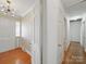 Hallway with wood floors and white doors, providing access to different rooms in the home at 2216 Griffith Rd, Monroe, NC 28112