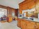 Cozy kitchen with wood cabinets, a built-in desk area and ample counter space for meal prep at 2216 Griffith Rd, Monroe, NC 28112