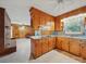 Functional kitchen with wood cabinetry, open layout, and view into an adjacent living area at 2216 Griffith Rd, Monroe, NC 28112
