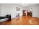 Bright living room features hardwood floors, a fireplace, and a view of the dining area at 2216 Griffith Rd, Monroe, NC 28112