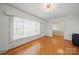 Bright living room with large window, hardwood floors, and modern lighting fixture at 2216 Griffith Rd, Monroe, NC 28112