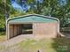 Exterior shot of the large outbuilding with a large eagle emblem at the top and wood paneled walls at 2216 Griffith Rd, Monroe, NC 28112
