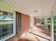 Spacious covered porch with tiled floor and brick accents, perfect for enjoying the outdoors at 2216 Griffith Rd, Monroe, NC 28112
