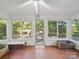 Bright sunroom featuring lots of windows, ceiling fan, and unique tile flooring looking out to the lovely landscaped outdoors at 2216 Griffith Rd, Monroe, NC 28112