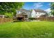 Spacious backyard with a deck, hot tub, fire pit area and lush green lawn, ideal for outdoor activities at 2217 Yadkin Ave, Charlotte, NC 28205