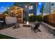 Inviting backyard with a fire pit, hot tub, and string lights, perfect for evening relaxation and entertainment at 2217 Yadkin Ave, Charlotte, NC 28205