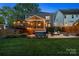 Expansive backyard featuring a deck, screened porch, hot tub, fire pit area and lush green lawn at 2217 Yadkin Ave, Charlotte, NC 28205