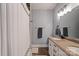 Bathroom featuring a shower with a curtain and a granite vanity with double sinks at 2217 Yadkin Ave, Charlotte, NC 28205