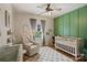 Cozy Bedroom featuring a modern crib, accent wall, and window with natural light at 2217 Yadkin Ave, Charlotte, NC 28205