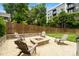 Cozy backyard fire pit with Adirondack chairs, perfect for outdoor gatherings and enjoying the evening ambiance at 2217 Yadkin Ave, Charlotte, NC 28205