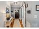 Welcoming foyer with a dark wood front door, light gray walls, hardwood floors, and an open sliding door at 2217 Yadkin Ave, Charlotte, NC 28205