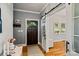 Elegant foyer featuring a dark wood front door, hardwood floors, and stylish sliding barn door at 2217 Yadkin Ave, Charlotte, NC 28205