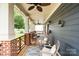Relaxing front porch featuring comfortable seating, ceiling fans, and stylish decor and wood and brick accents at 2217 Yadkin Ave, Charlotte, NC 28205