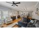 Open-concept living room with gray sectional sofa, hardwood floors, and eat-in kitchen view at 2217 Yadkin Ave, Charlotte, NC 28205
